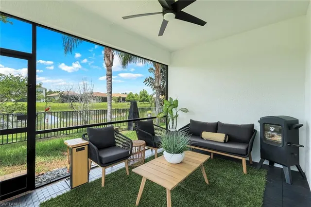 a living room with furniture and a floor to ceiling window