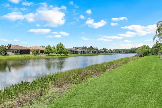 a view of a lake with houses in the back