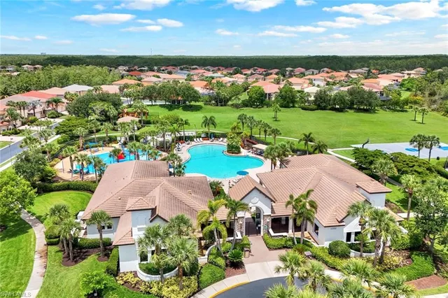 an aerial view of a house with a garden and lake view