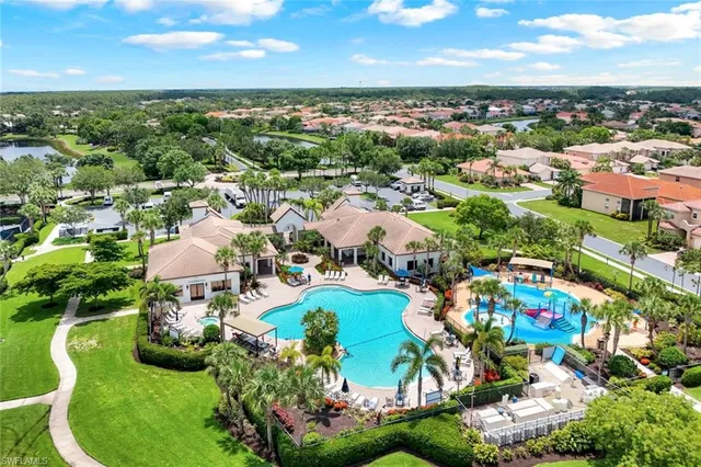 an aerial view of residential houses with outdoor space and trees
