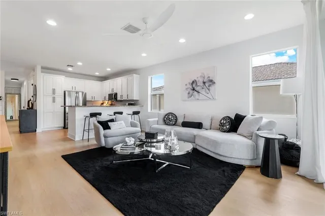 a living room with furniture kitchen view and a table