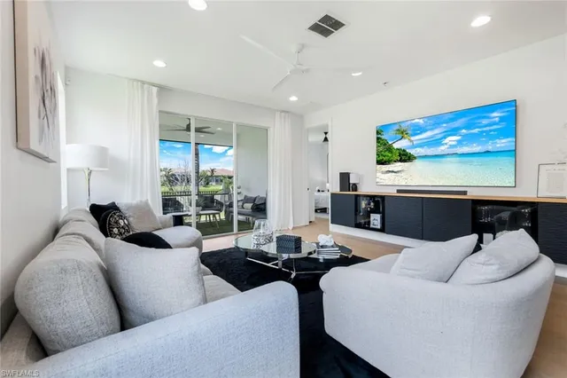 a living room with furniture and large window