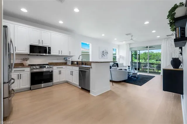a kitchen with a stove a sink and a refrigerator