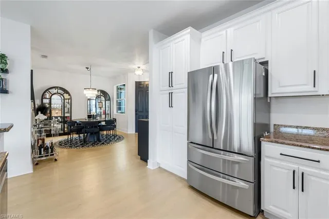 a kitchen with stainless steel appliances a refrigerator sink and cabinets