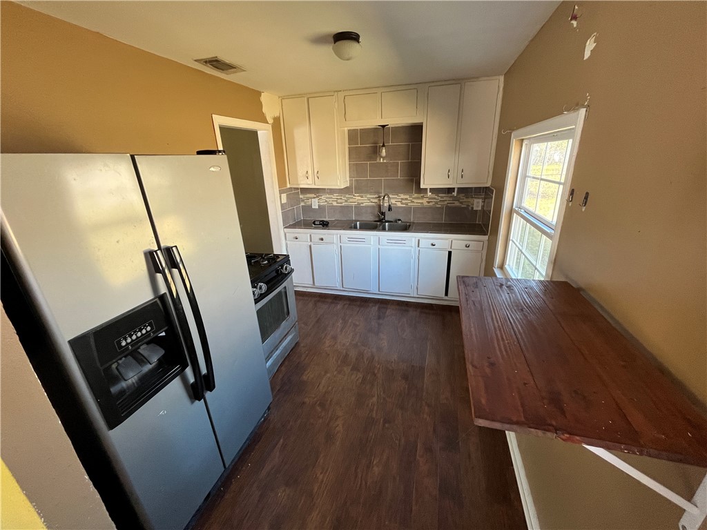 123 Burnet Street Port Lavaca, TX 77979 - Photo 3 of 9 a kitchen with sink window and refrigerator