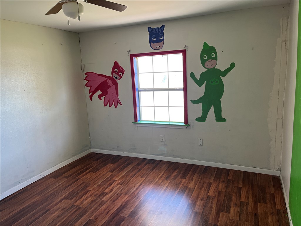123 Burnet Street Port Lavaca, TX 77979 - Photo 7 of 9 a room with window and a wooden floor