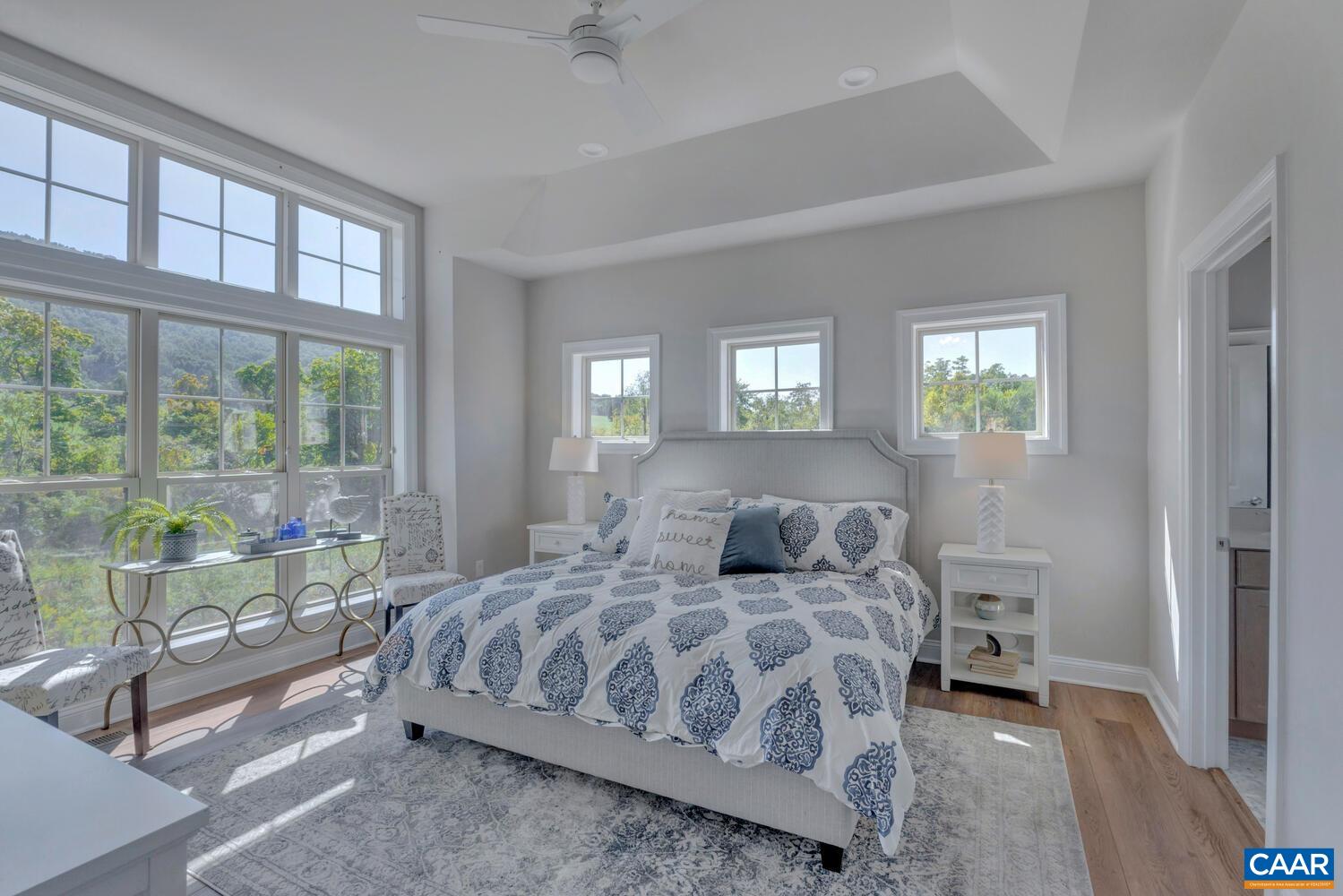 2 B Agatha Ridge Lane, Unit LOT 2 Crozet, VA 22932 - Photo 19 of 37 a bedroom with a large bed and a lamp on table