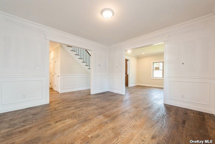 608 Meadowbrook Road North Merrick, NY 11566 - Photo 14 of 36 an empty room with wooden floor and windows