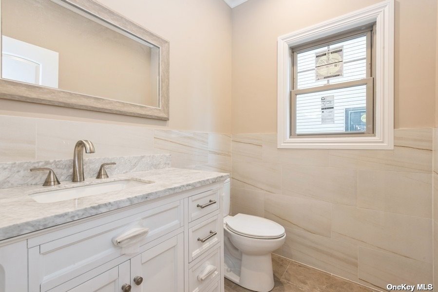608 Meadowbrook Road North Merrick, NY 11566 - Photo 20 of 36 a bathroom with a granite countertop toilet sink and mirror