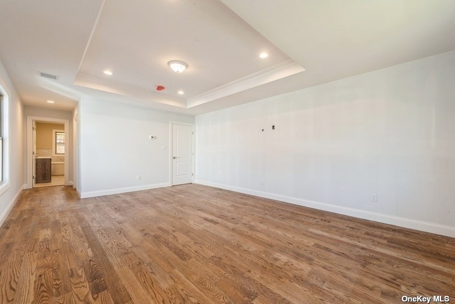 608 Meadowbrook Road North Merrick, NY 11566 - Photo 23 of 36 a view of an empty room with wooden floor