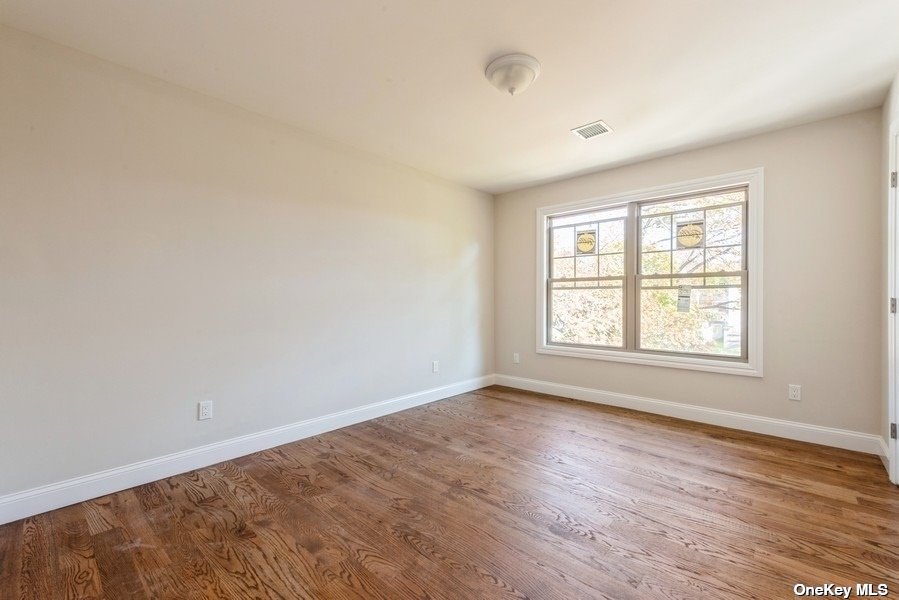 608 Meadowbrook Road North Merrick, NY 11566 - Photo 28 of 36 a view of an empty room with wooden floor and a window