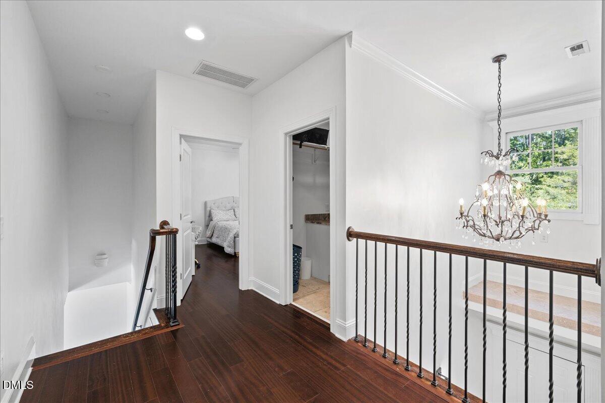1304 Flying Hawk Road Apex, NC 27523 - Photo 26 of 52 a view of a hallway with wooden floor and stairs