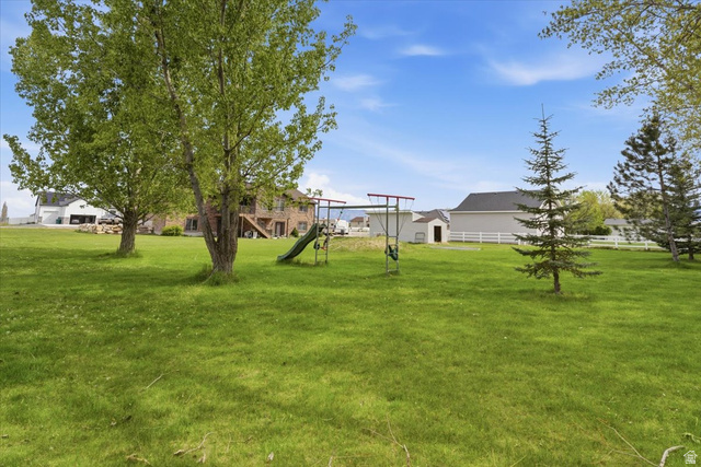 6237 West 4600th Street South Hooper, UT 84315 - Photo 46 of 48 View of green lawn featuring a residential view