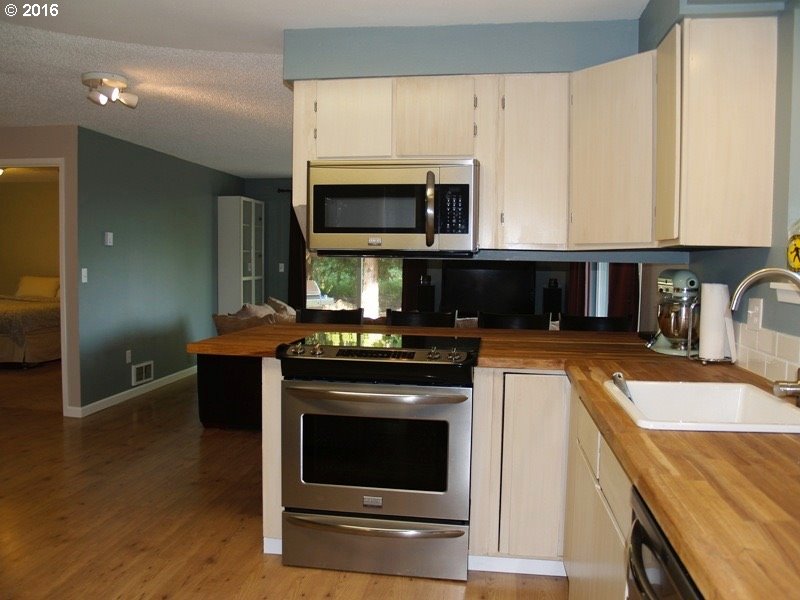 830 Northeast Bone Road Stevenson, WA 98648 - Photo 6 of 18 a kitchen with stainless steel appliances granite countertop a stove a microwave and a sink