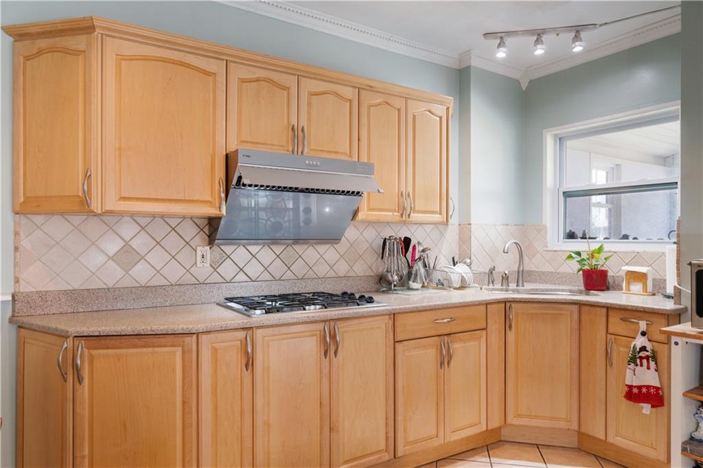3407 Ward Street Pittsburgh, PA 15213 - Photo 12 of 39 a kitchen with stainless steel appliances granite countertop a sink window and cabinets