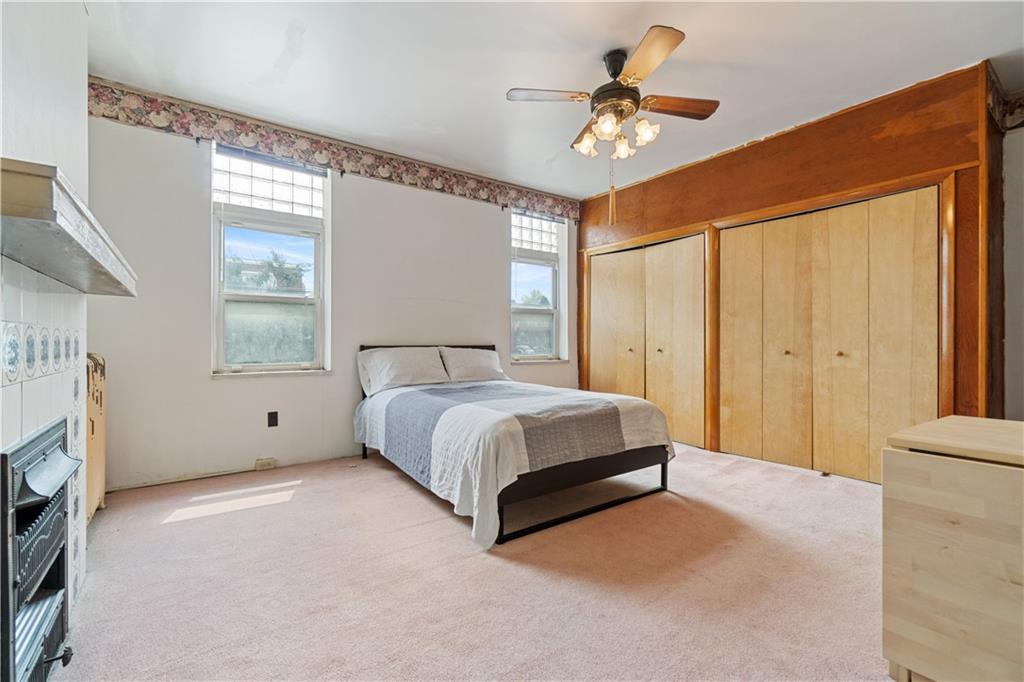 3407 Ward Street Pittsburgh, PA 15213 - Photo 16 of 39 a spacious bedroom with a bed and a chandelier