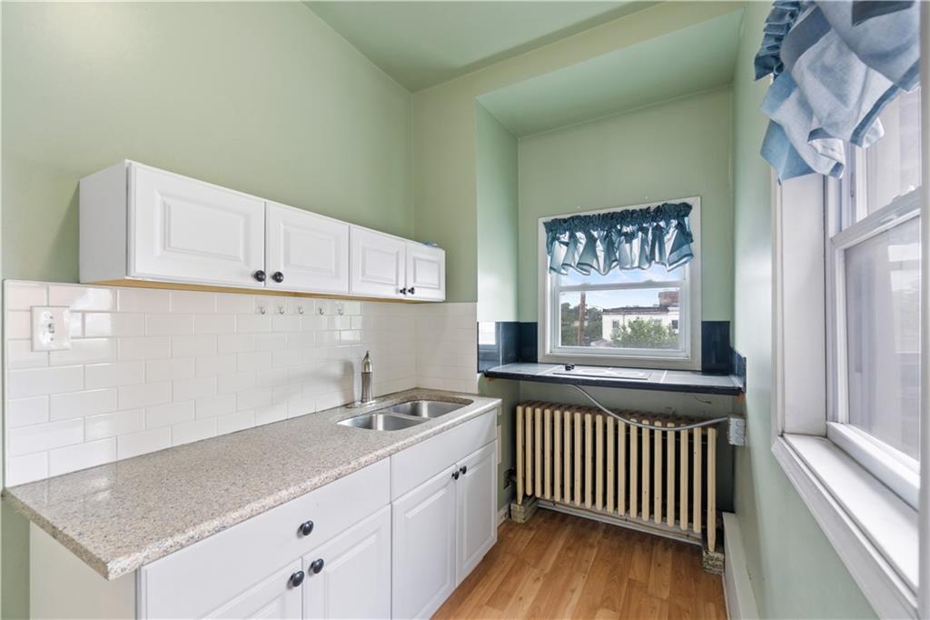 3407 Ward Street Pittsburgh, PA 15213 - Photo 18 of 39 a kitchen with granite countertop a sink and a stove top oven