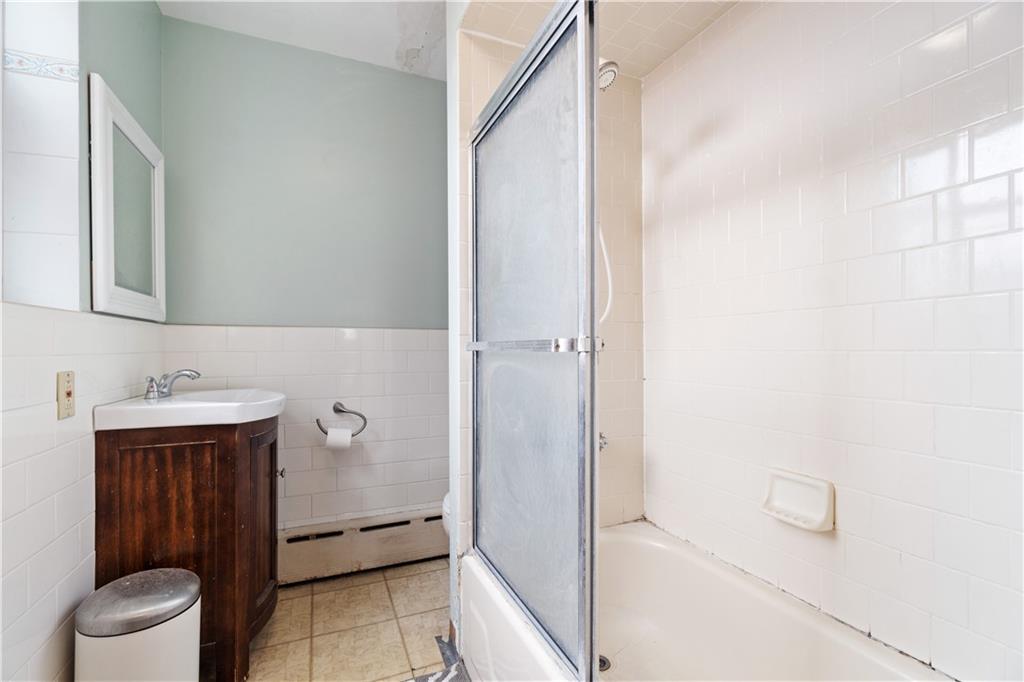 3407 Ward Street Pittsburgh, PA 15213 - Photo 19 of 39 a bathroom with a granite countertop sink toilet and shower