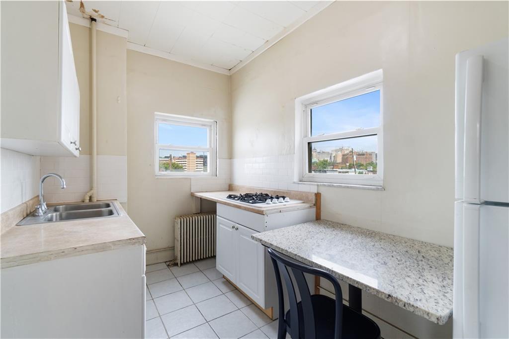 3407 Ward Street Pittsburgh, PA 15213 - Photo 24 of 39 a kitchen with a stove cabinets and wooden floor