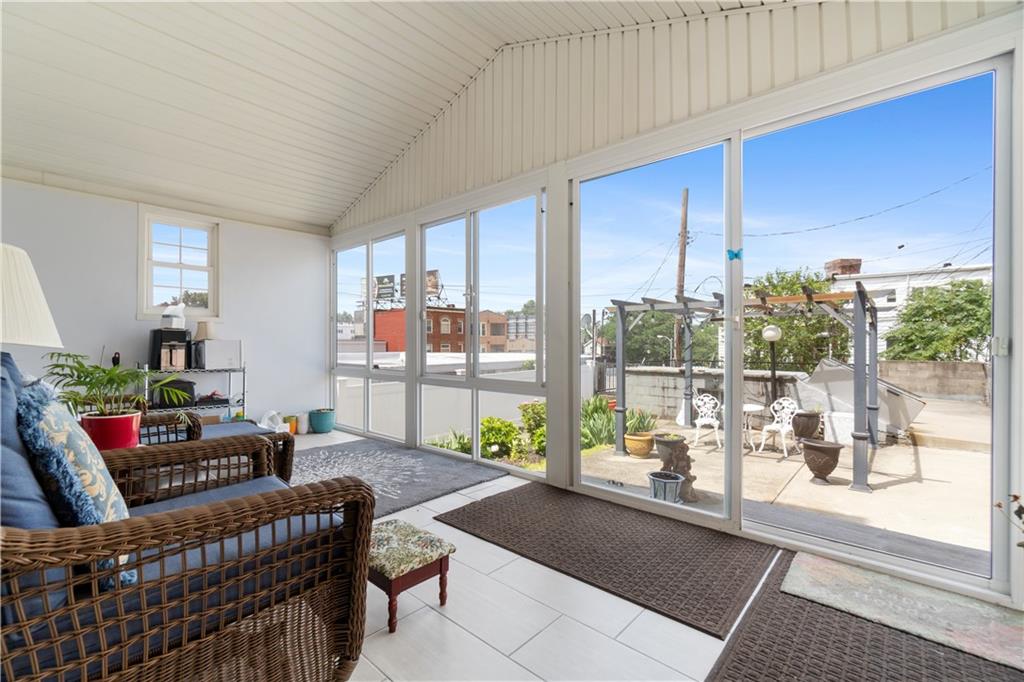 3407 Ward Street Pittsburgh, PA 15213 - Photo 26 of 39 a living room with furniture and a floor to ceiling window