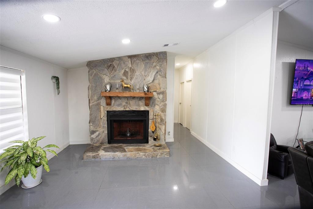 41 Ferguson Lane Frostproof, FL 33843 - Photo 11 of 33 a living room with furniture and a fireplace