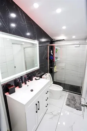 a bedroom with two beds and a desk