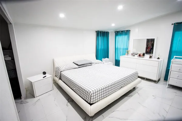 a bedroom with a bed and a window