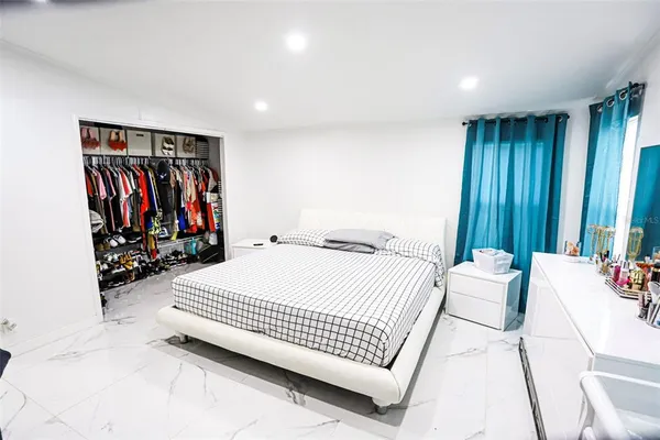 a bedroom with a bed and a flat screen television