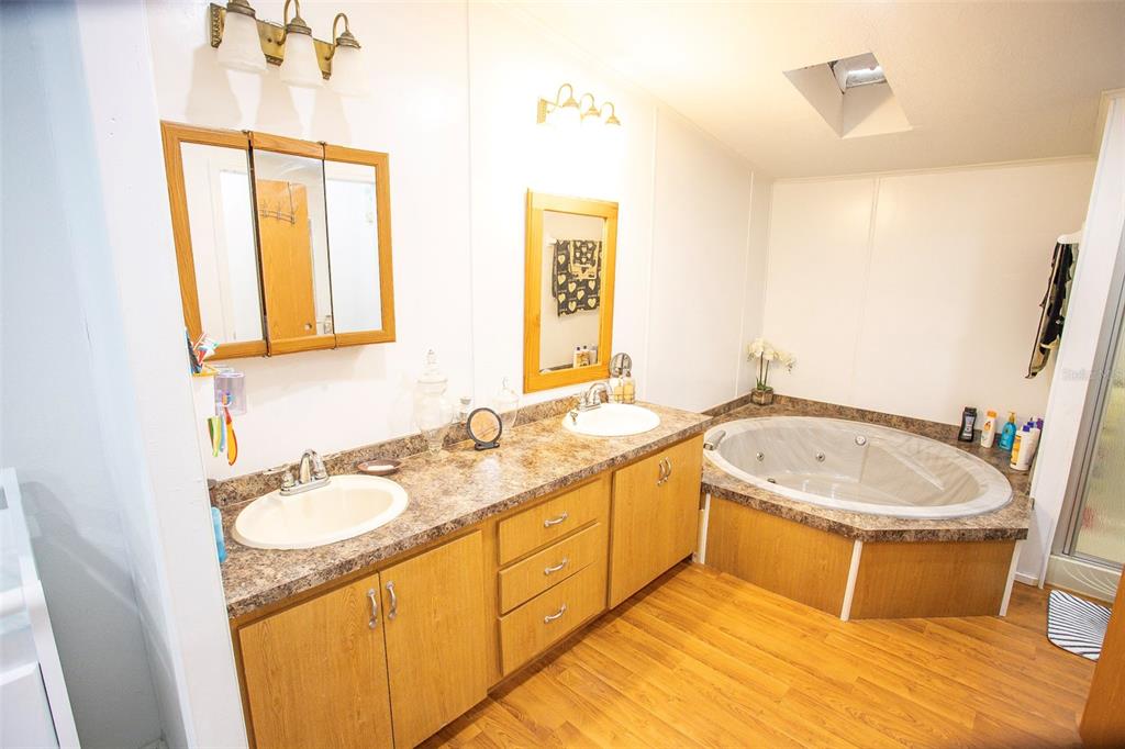 41 Ferguson Lane Frostproof, FL 33843 - Photo 22 of 33 a bathroom with a granite countertop sink and a mirror