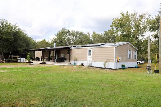a view of a table and chairs under an umbrella
