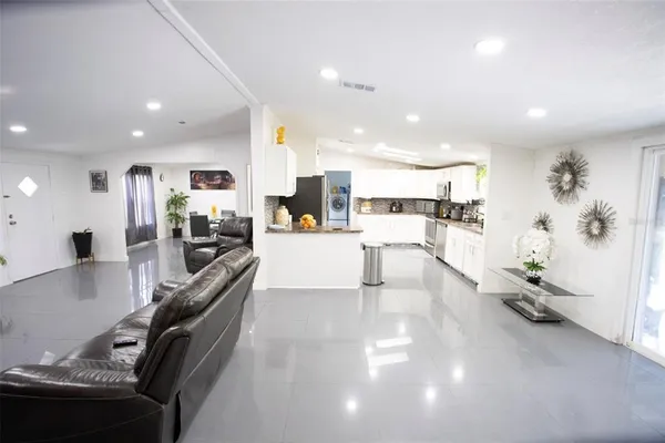 a view of a living room and kitchen with furniture