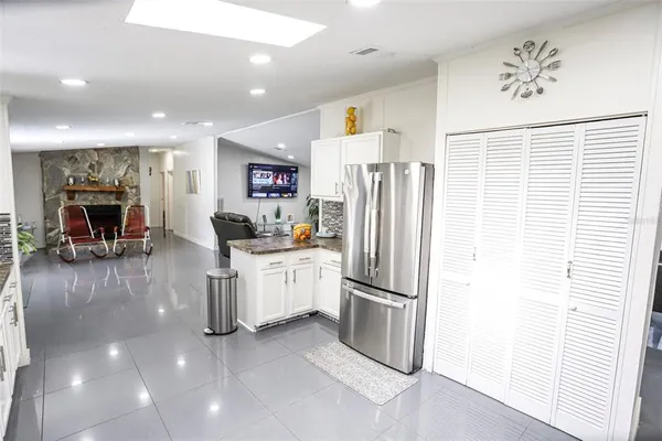 a kitchen with stainless steel appliances a refrigerator and a stove top oven