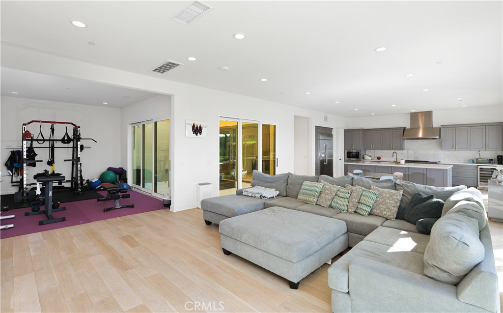 108 Salt Spring Irvine, CA 92602 - Photo 16 of 75 a living room with furniture gym equipment and large windows