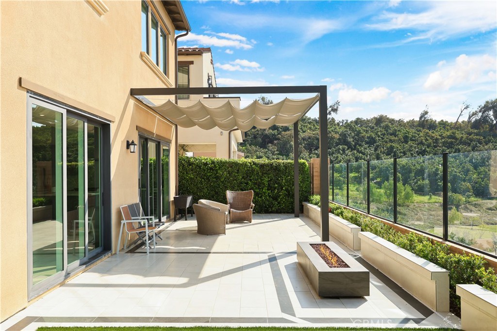 108 Salt Spring Irvine, CA 92602 - Photo 23 of 75 a view of a patio with a table chairs and a floor to ceiling window