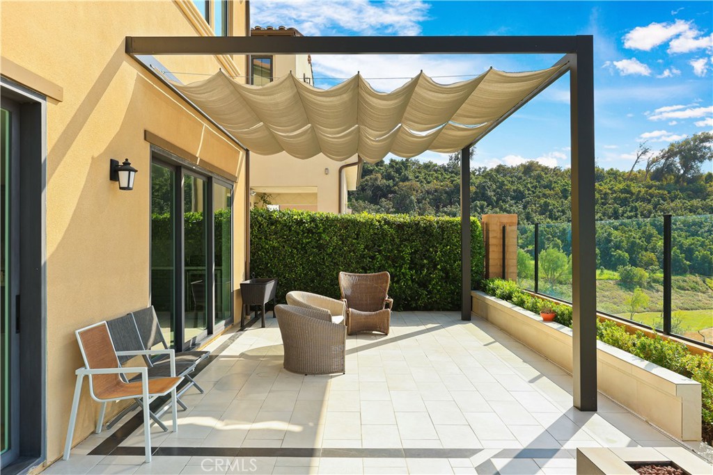 108 Salt Spring Irvine, CA 92602 - Photo 30 of 75 a view of a chair and tables in the balcony