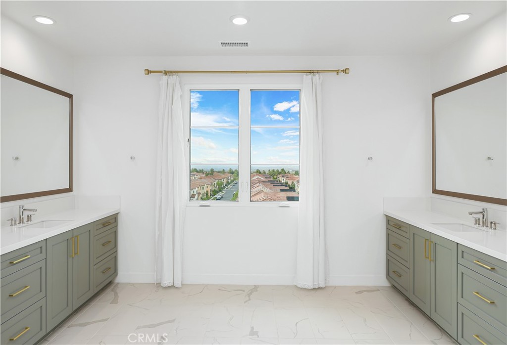 108 Salt Spring Irvine, CA 92602 - Photo 37 of 75 a spacious bathroom with a double vanity sink a mirror and a shower
