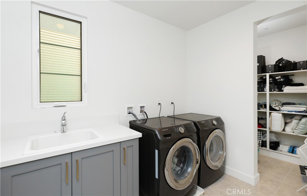 108 Salt Spring Irvine, CA 92602 - Photo 40 of 75 a utility room with sink dryer and washer