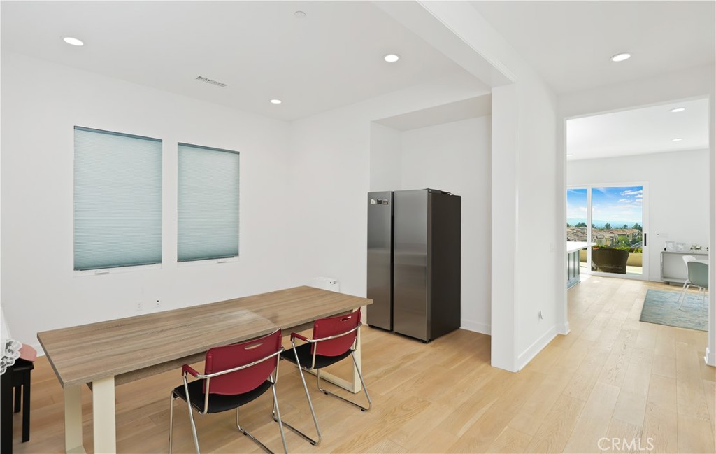 108 Salt Spring Irvine, CA 92602 - Photo 4 of 75 a kitchen with stainless steel appliances kitchen island hardwood floor and wooden cabinets