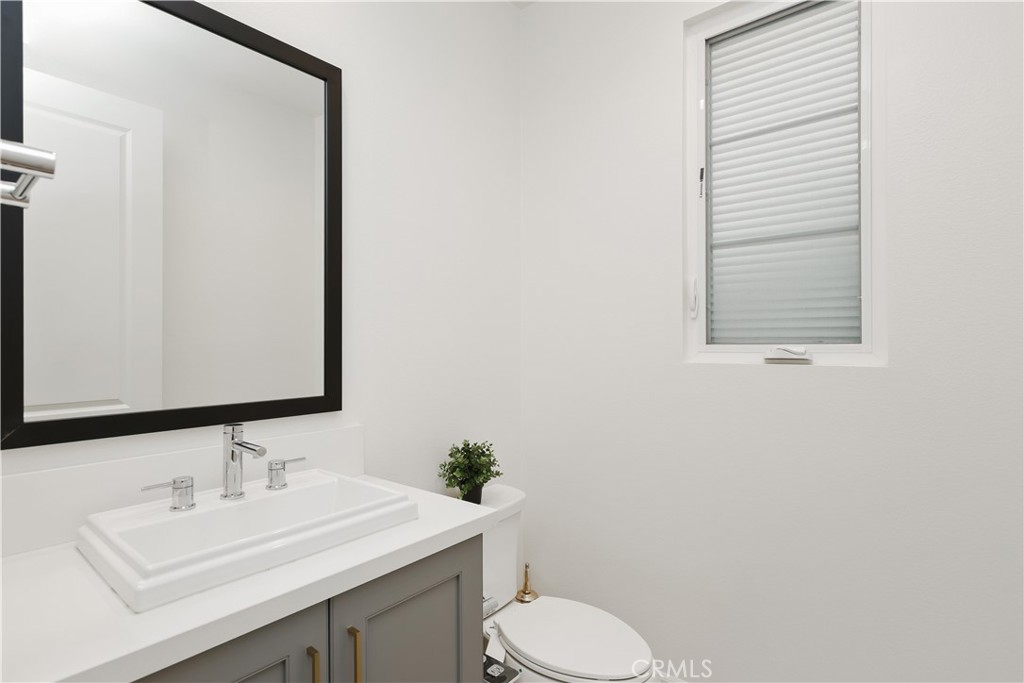 108 Salt Spring Irvine, CA 92602 - Photo 57 of 75 a bathroom with a sink a toilet and mirror