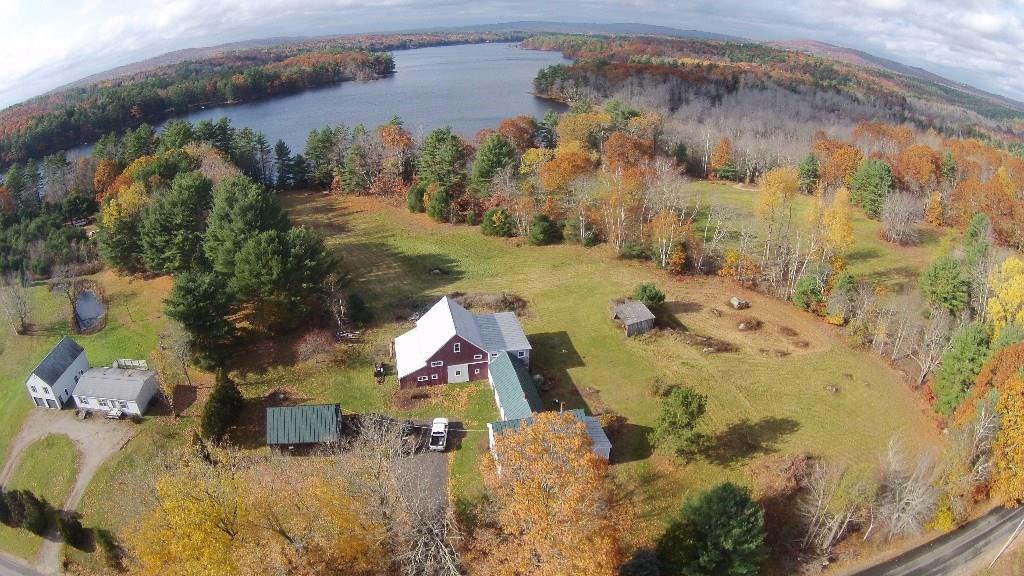 900 Wottons Mill Road Warren, ME 04864 - Photo 2 of 25 Aerial view of house, pastures, and lake