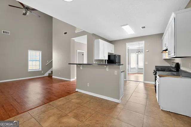 a view of a kitchen with a sink cabinets and a window