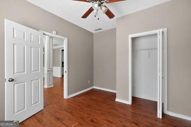 wooden floor in an empty room with a window