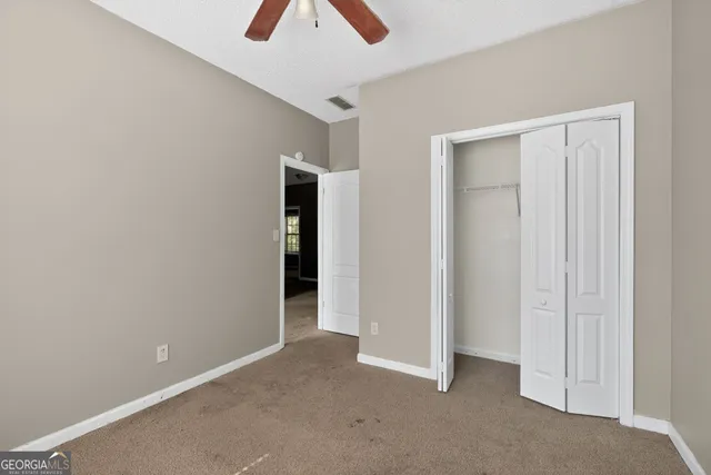 an empty room with closet and window