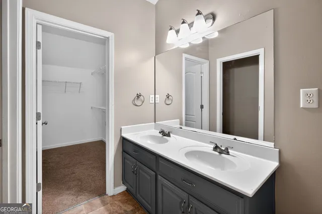a bathroom with a sink vanity and a mirror