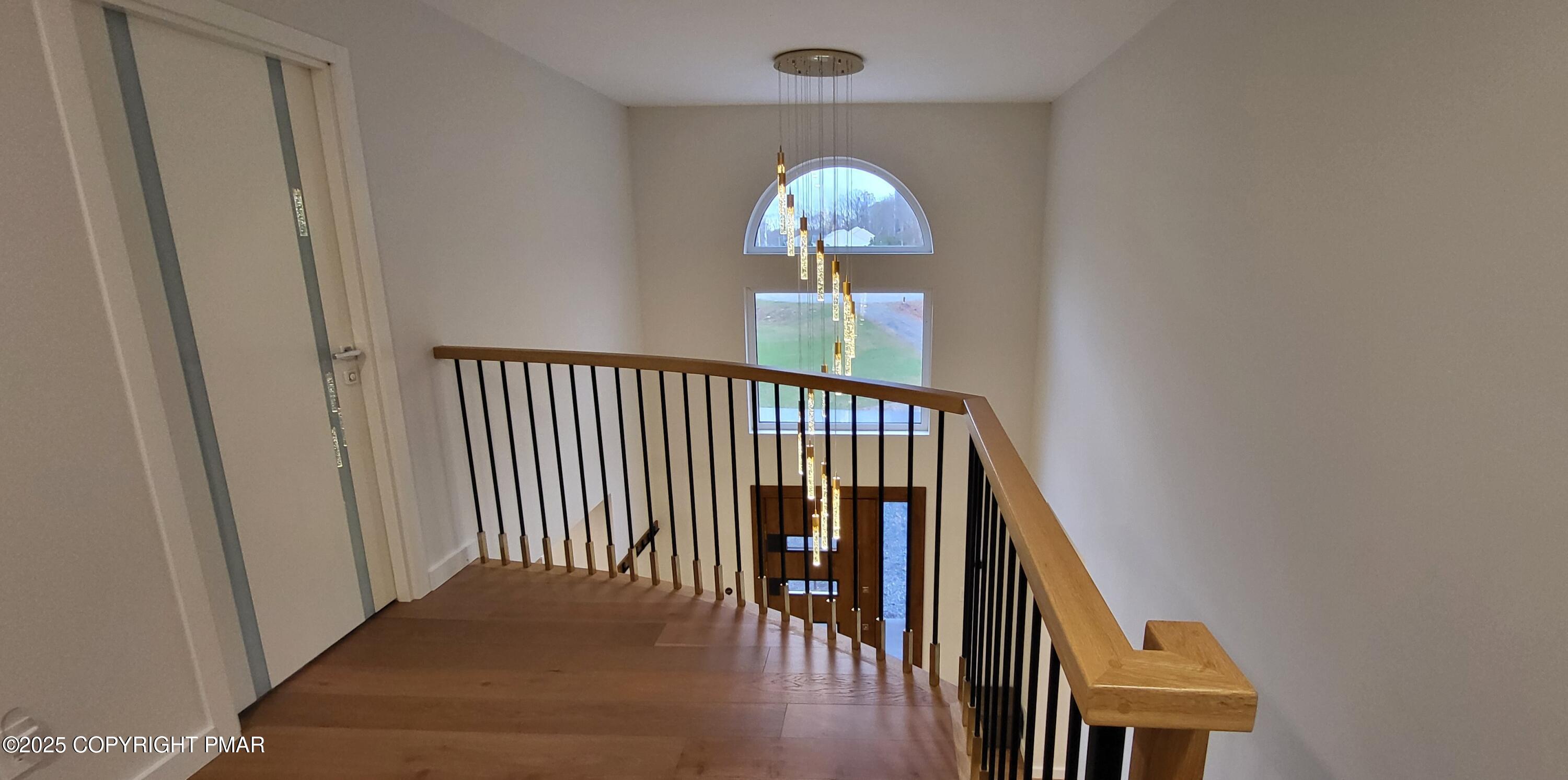 2226 Bedford Court Bushkill, PA 18371 - Photo 44 of 79 a view of a hallway with wooden floor and staircase