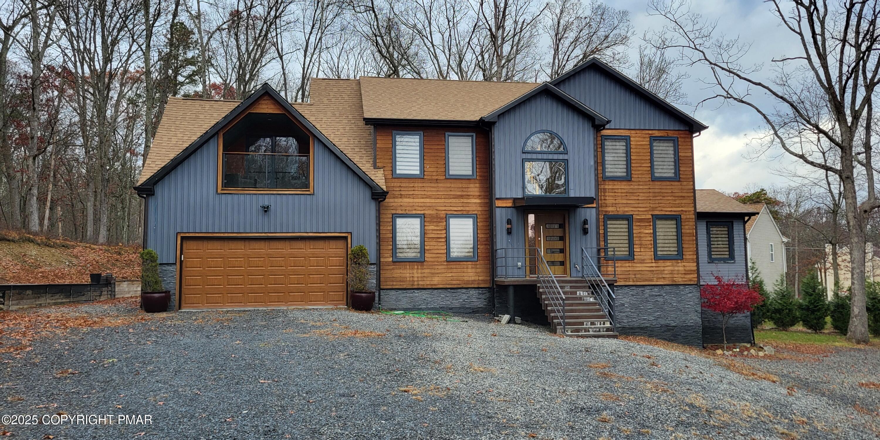 2226 Bedford Court Bushkill, PA 18371 - Photo 50 of 79 a front view of a house with a yard and garage