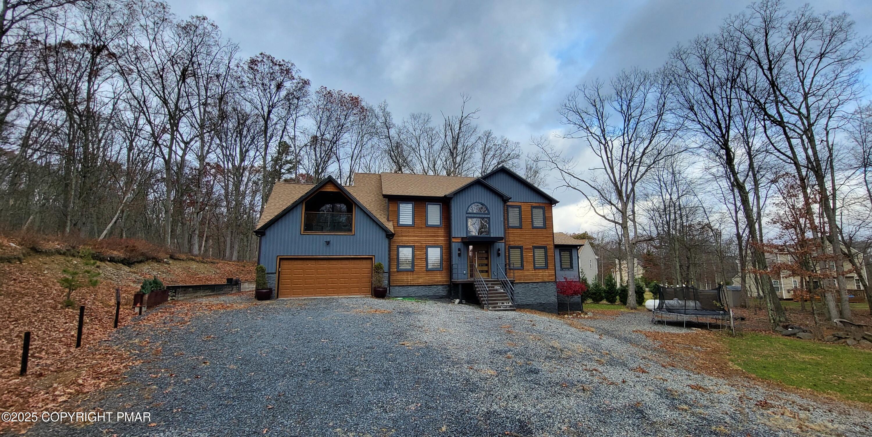 2226 Bedford Court Bushkill, PA 18371 - Photo 51 of 79 a front view of a house with a yard and garage