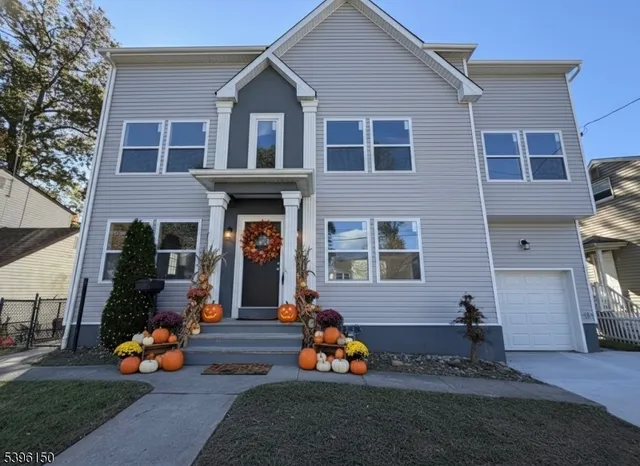 a front view of a house with lots of stuff and trees