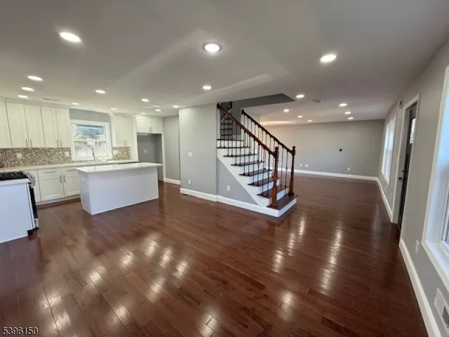 a view of a kitchen with cabinets and wooden floor
