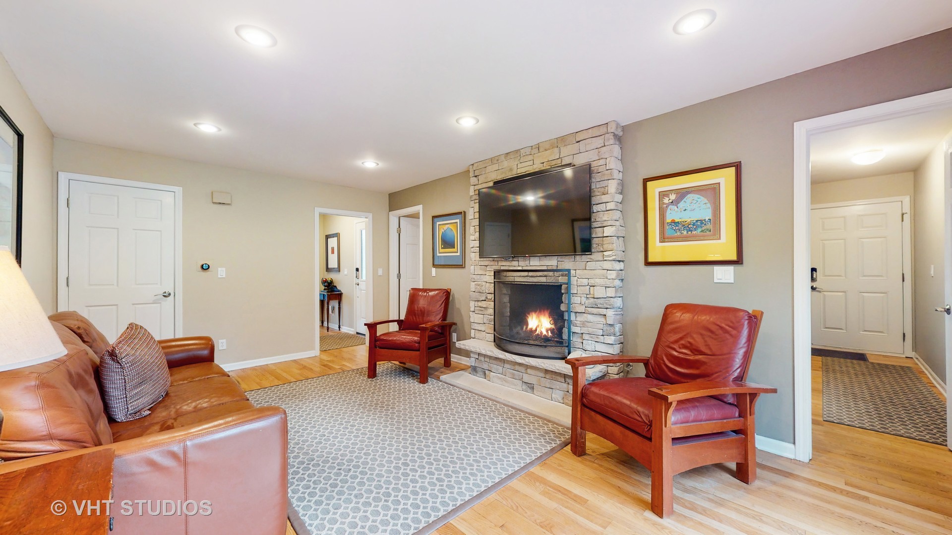 256 Stonegate Road Trout Valley, IL 60013 - Photo 6 of 52 a living room with furniture a fireplace and a flat screen tv